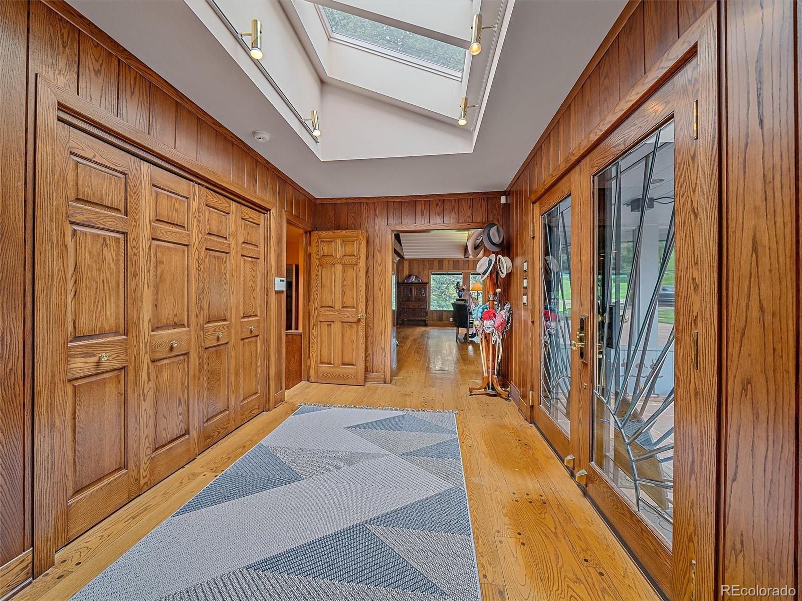 32453 Upper Bear Creek Road Evergreen, CO 80439 - Photo 6 of 48 a view of a hallway with wooden shelves