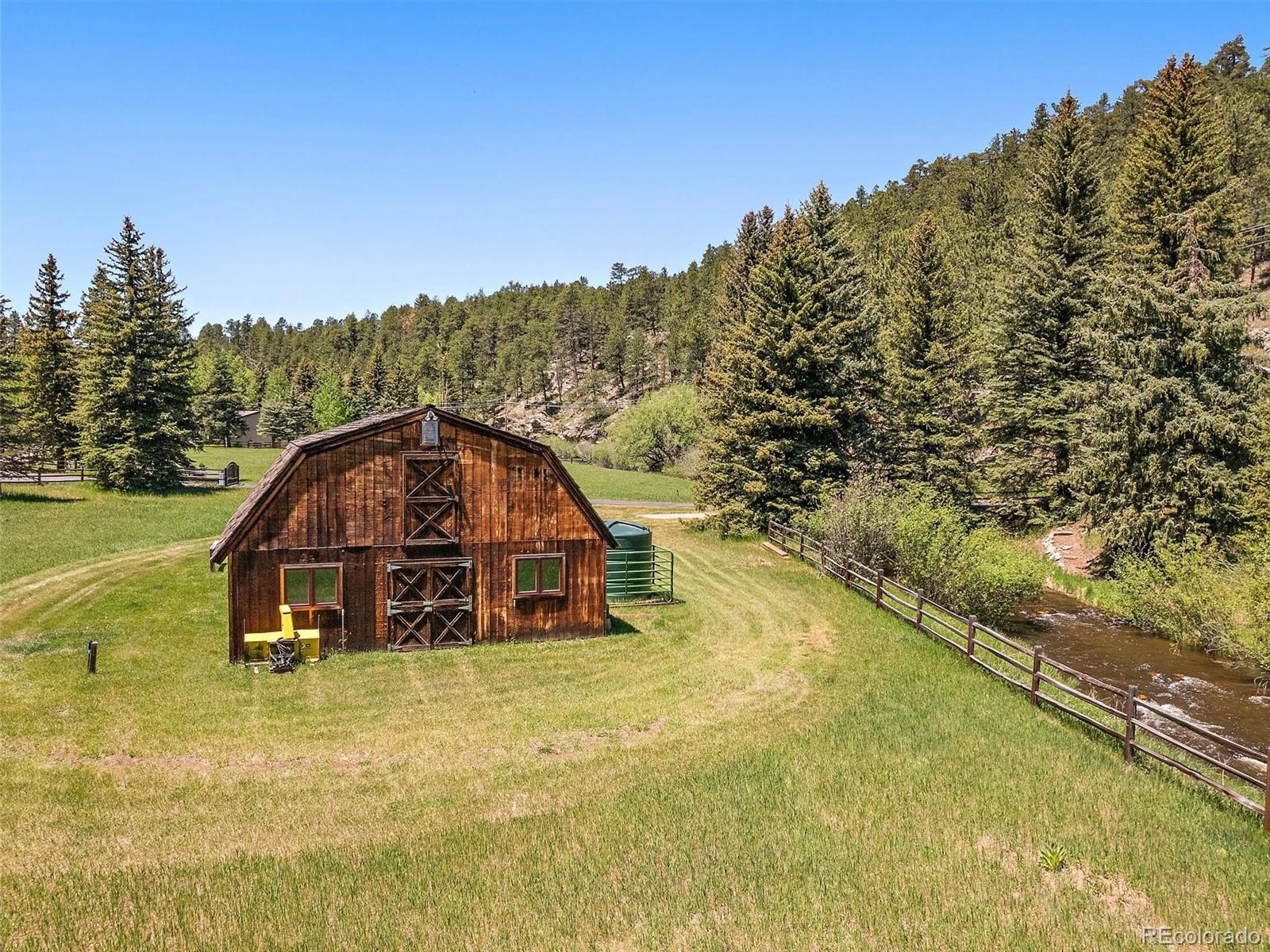 32453 Upper Bear Creek Road Evergreen, CO 80439 - Photo 7 of 48 a view of a mini pool with a yard