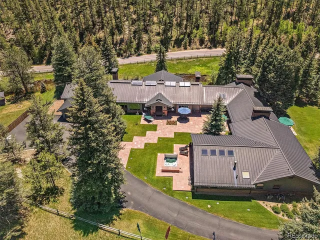 an aerial view of a house with outdoor space pool seating area and yard