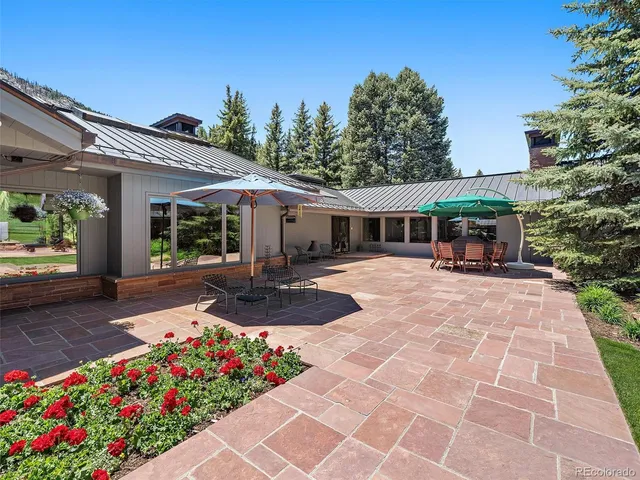 a view of a house with sitting area and garden