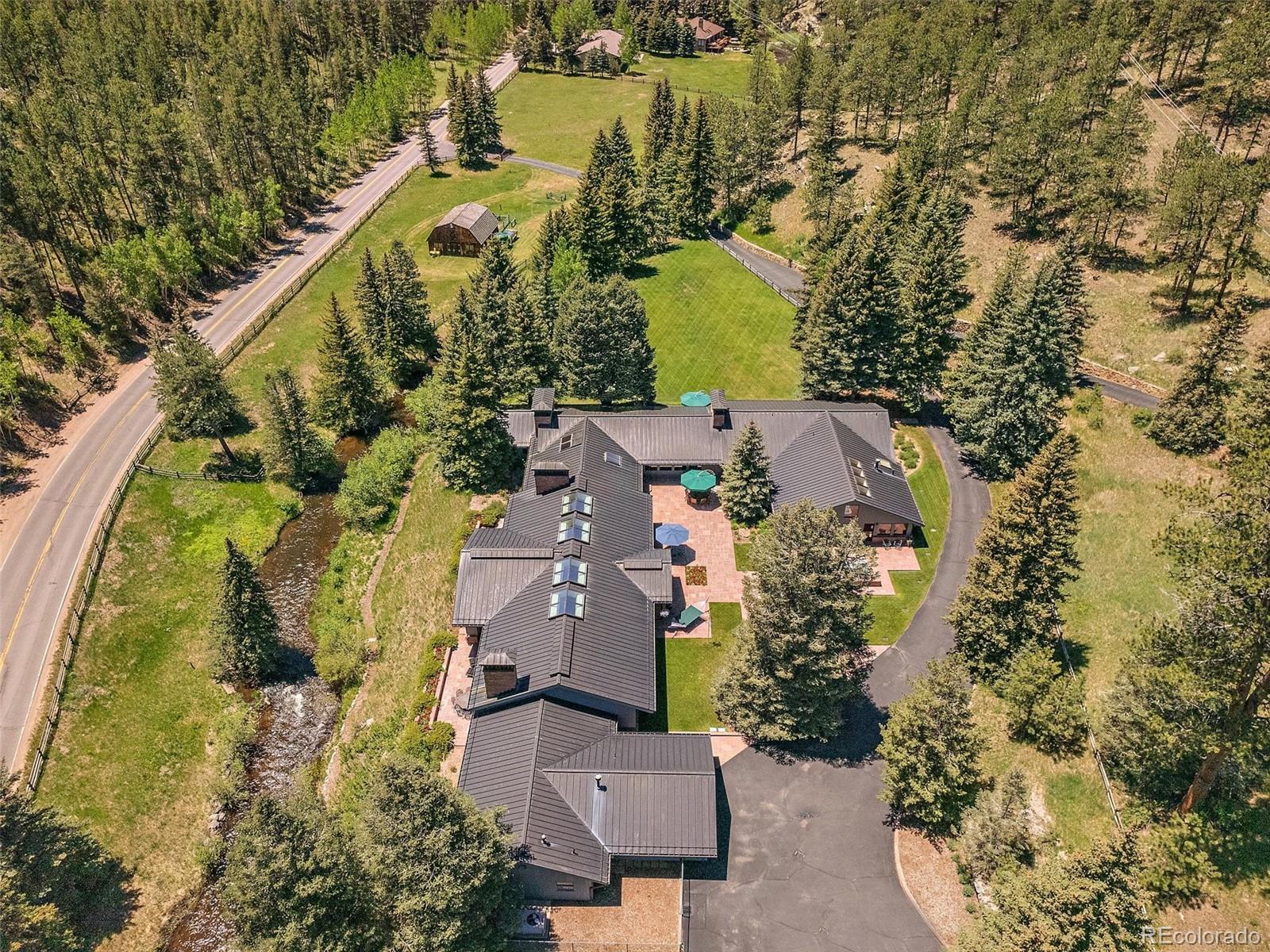 32453 Upper Bear Creek Road Evergreen, CO 80439 - Photo 10 of 48 an aerial view of a house with a lake view