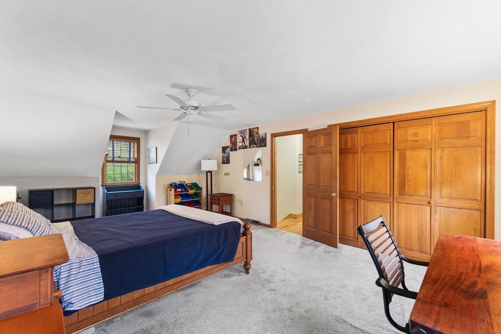 2 McTee Drive Norton, MA 02766 - Photo 27 of 42 a spacious bedroom with a bed a table and chair