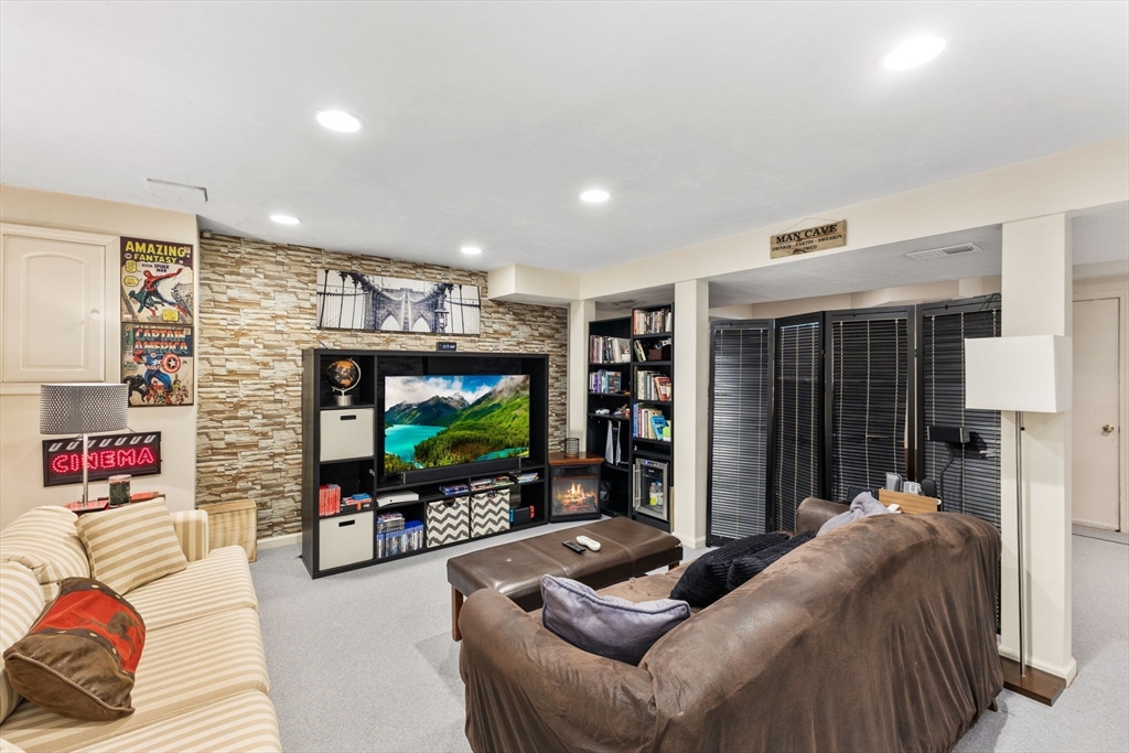 2 McTee Drive Norton, MA 02766 - Photo 32 of 42 a living room with furniture and a flat screen tv
