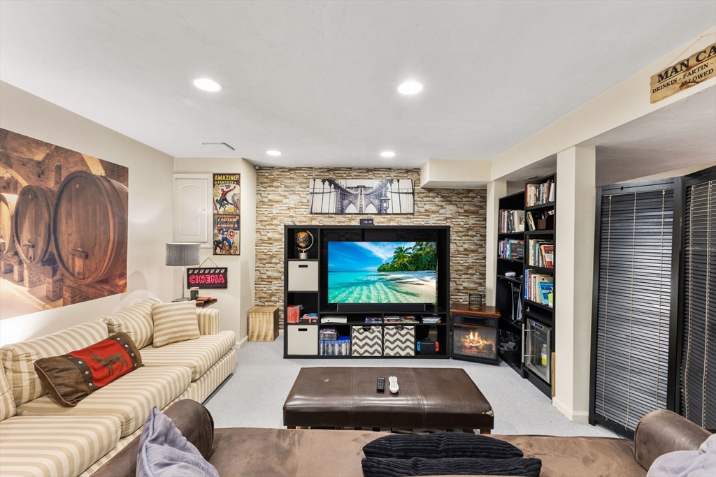 2 McTee Drive Norton, MA 02766 - Photo 33 of 42 a living room with furniture and a flat screen tv
