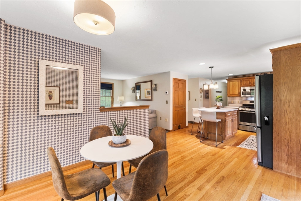 2 McTee Drive Norton, MA 02766 - Photo 10 of 42 a kitchen with stainless steel appliances kitchen island granite countertop a table chairs and a refrigerator