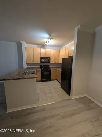 a kitchen with cabinets and steel appliances