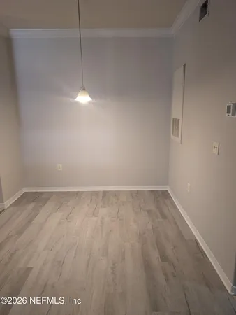 a view of a room with an empty space and a window