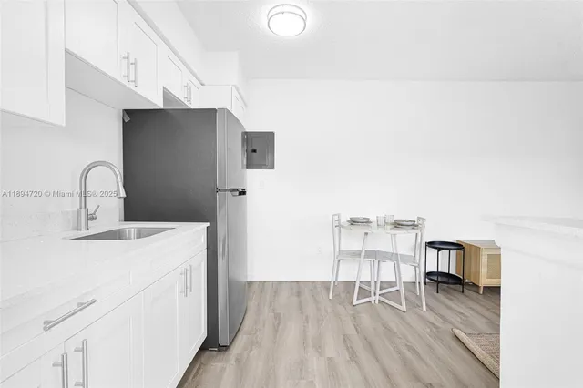a kitchen with stainless steel appliances a stove a sink and a refrigerator