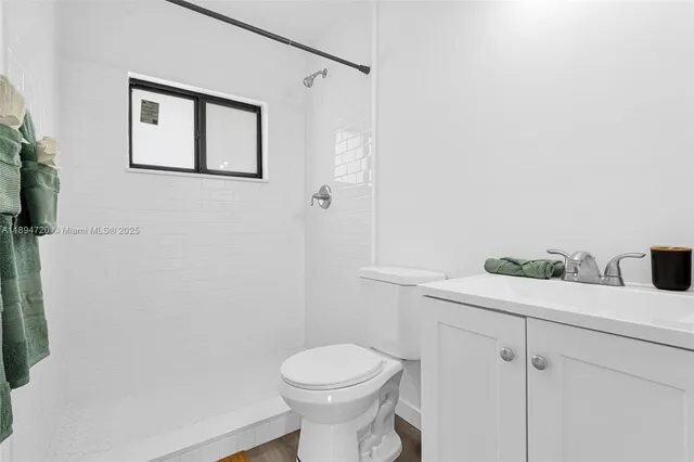 a white toilet sitting next to a bathroom sink