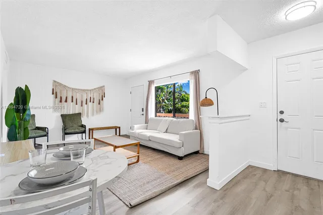 a kitchen with cabinets appliances a sink and a window