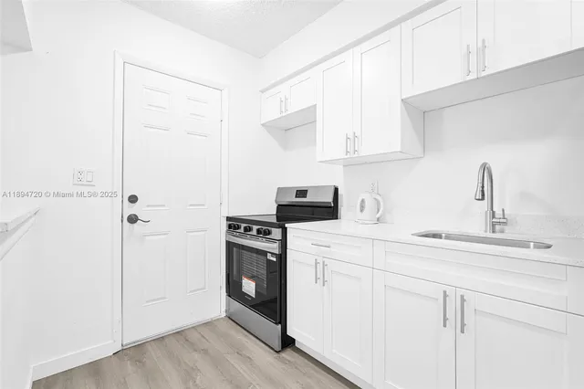 a kitchen with a sink appliances and cabinets