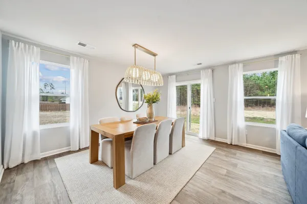 a very nice looking room with a large window table and chairs