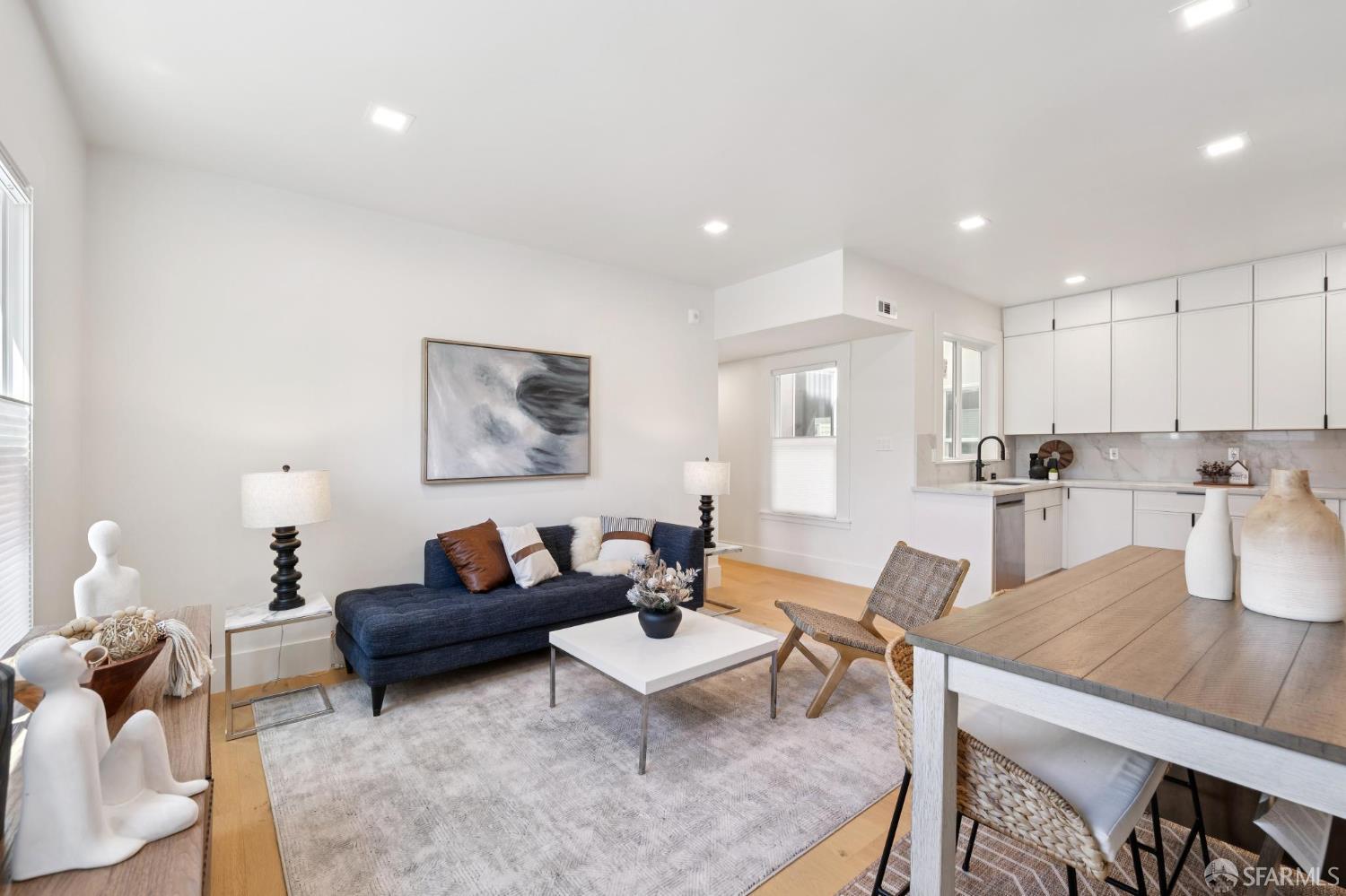 31 Romolo Place, Unit 4 San Francisco, CA 94133 - Photo 4 of 23 a living room with furniture a rug kitchen view and a table