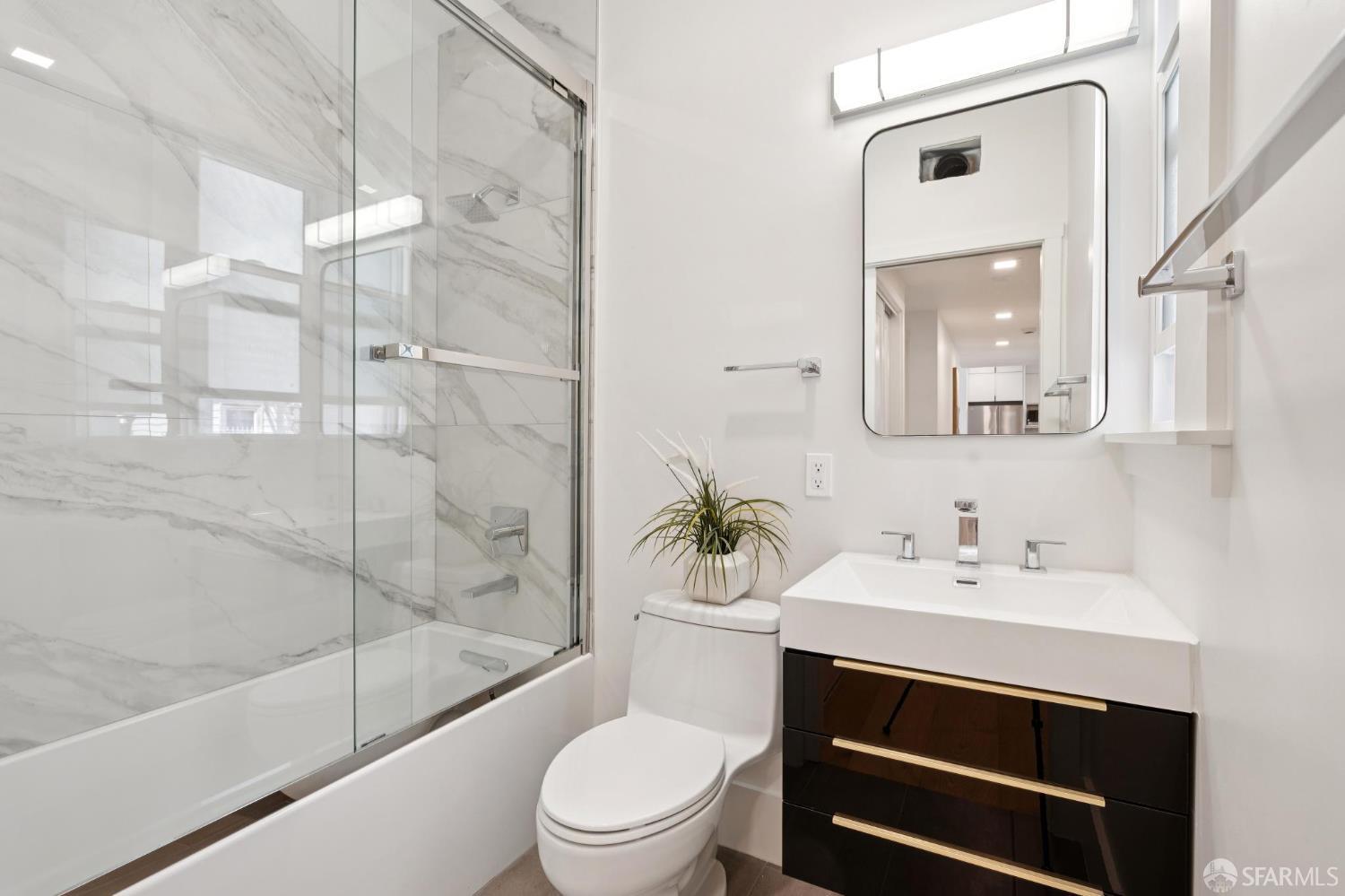 31 Romolo Place, Unit 4 San Francisco, CA 94133 - Photo 8 of 23 a bathroom with a sink a toilet and shower