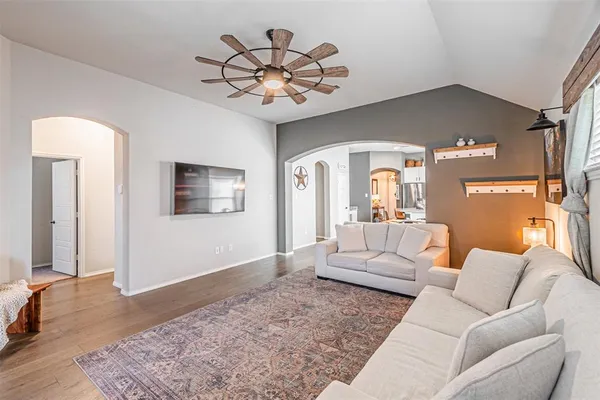 a living room with furniture and a chandelier