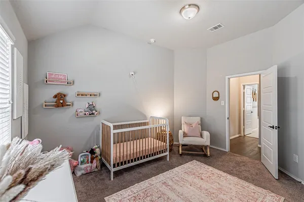 a view of a bedroom with baby crib