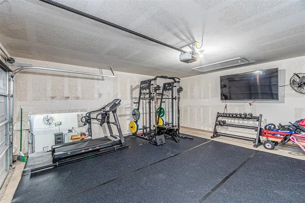 a bedroom with furniture and a flat screen tv
