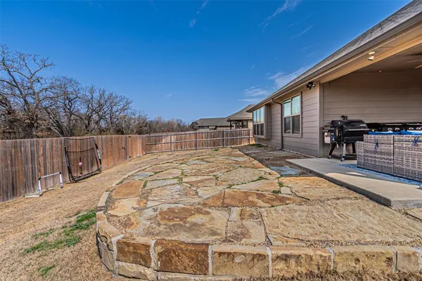 a swimming pool with outdoor seating and yard