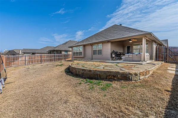 a view of a house with a yard and sitting area