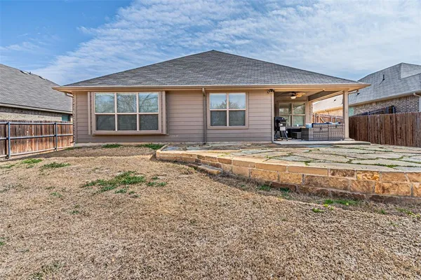 a view of a house with a yard and sitting area
