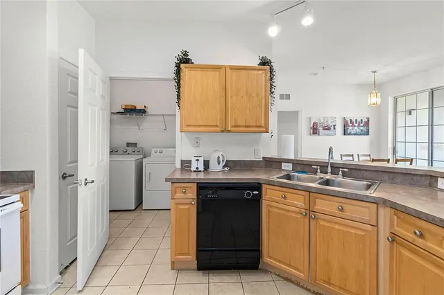 a kitchen with a sink stove top oven and cabinets