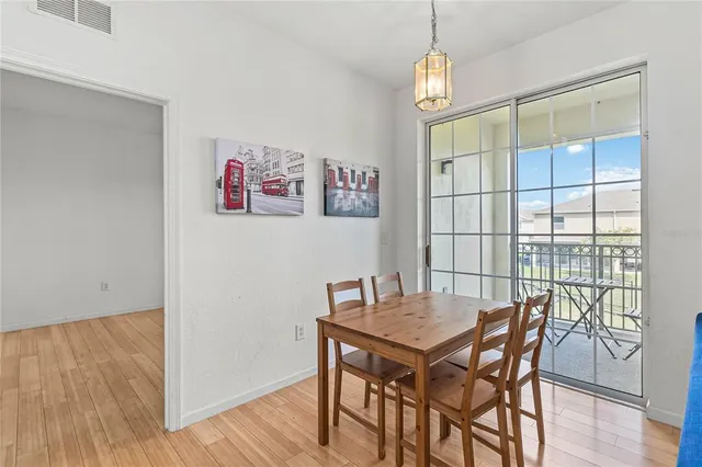 a view of a dining room with furniture window and wooden floor