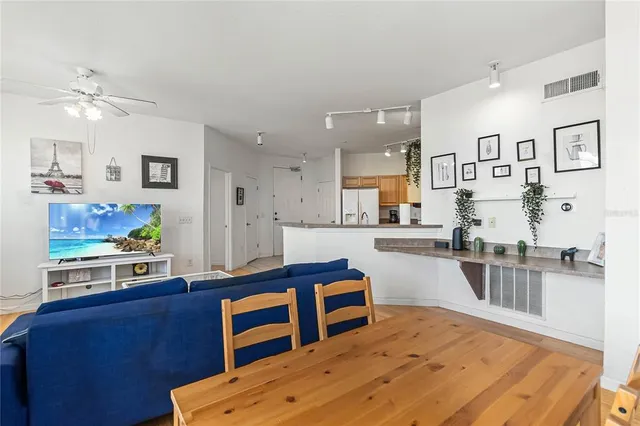 a kitchen with stainless steel appliances kitchen island granite countertop a sink stove and wooden cabinets