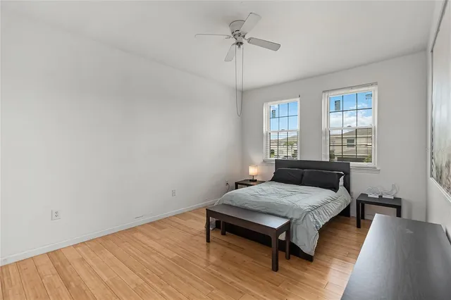 a bedroom with a bed and wooden floor