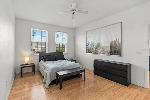 a bedroom with a bed and wooden floor