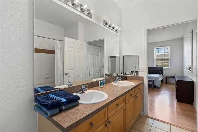 a spacious bathroom with a granite countertop sink and a mirror
