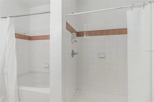 a bathroom with a shower and a shower