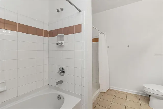 a bathroom with a bathtub and a toilet