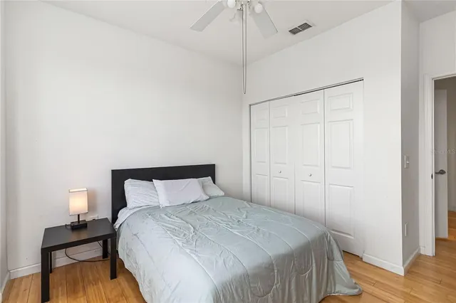 a bedroom with a bed and wooden floor