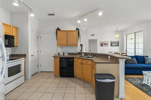 a large kitchen with stainless steel appliances granite countertop a stove and a sink
