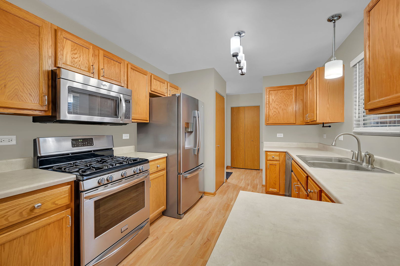 1640 Clover Court Romeoville, IL 60446 - Photo 11 of 30 a kitchen with stainless steel appliances granite countertop a stove sink microwave and refrigerator