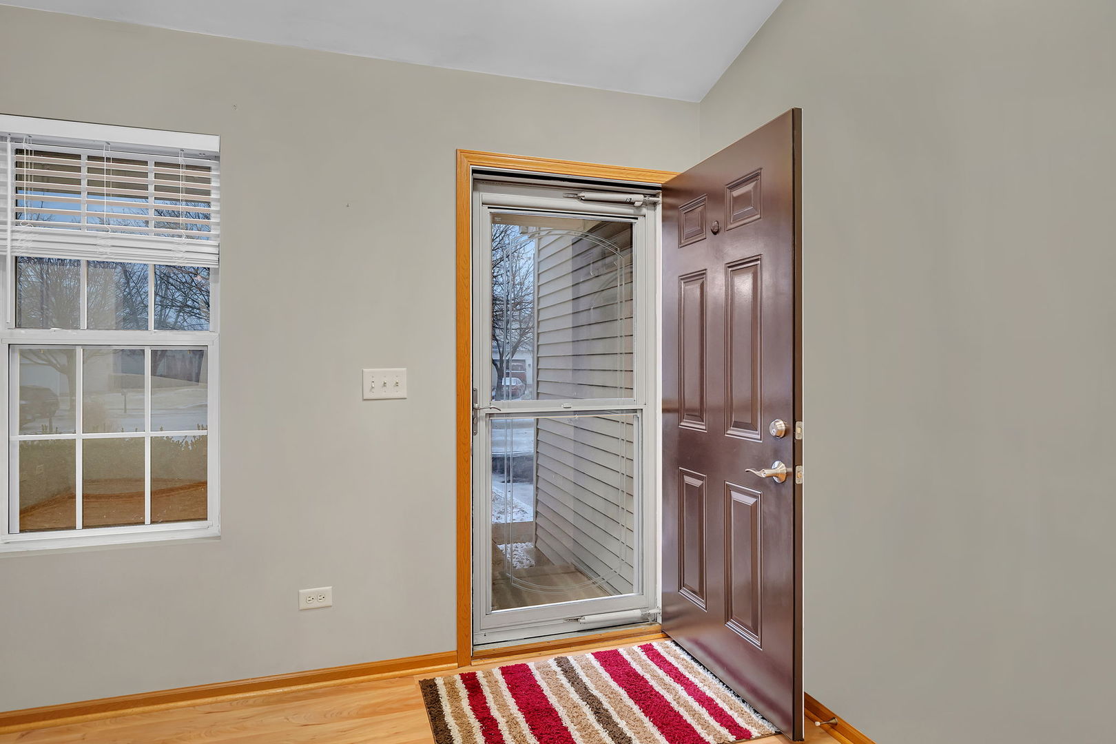 1640 Clover Court Romeoville, IL 60446 - Photo 6 of 30 a view of a hallway with wooden floor and windows
