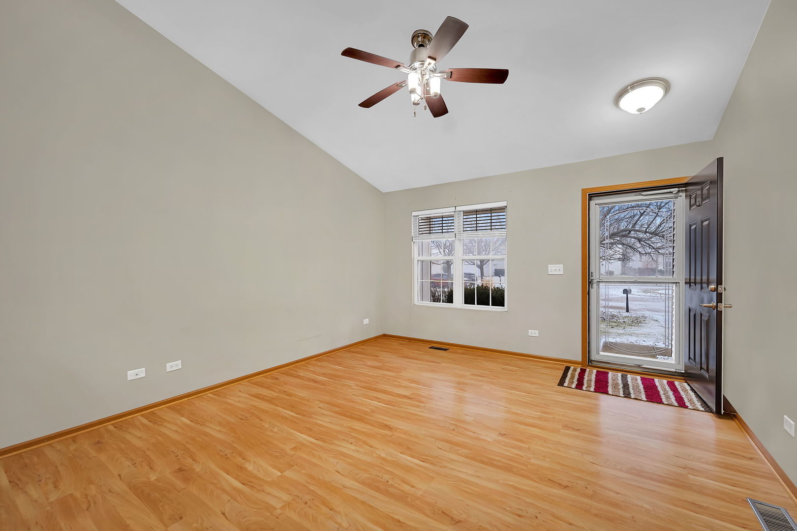 1640 Clover Court Romeoville, IL 60446 - Photo 8 of 30 a view of an empty room with a window and wooden floor