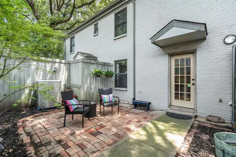 a view of a chairs and table in backyard of the house