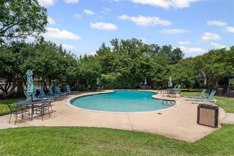 a view of a backyard with sitting area