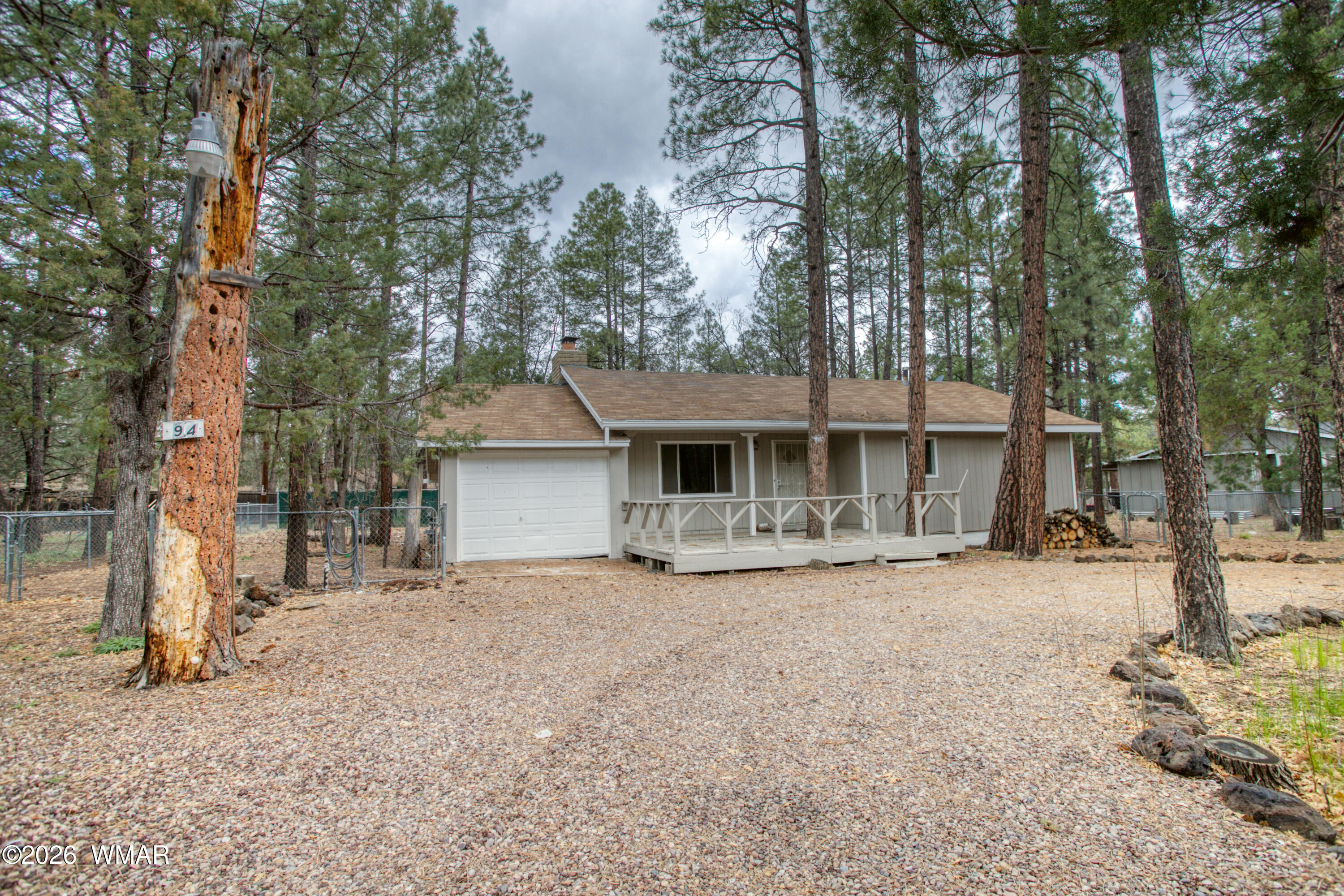 94 Southlake Road Lakeside, AZ 85929 - Photo 1 of 16 a front view of a house with a yard and garage