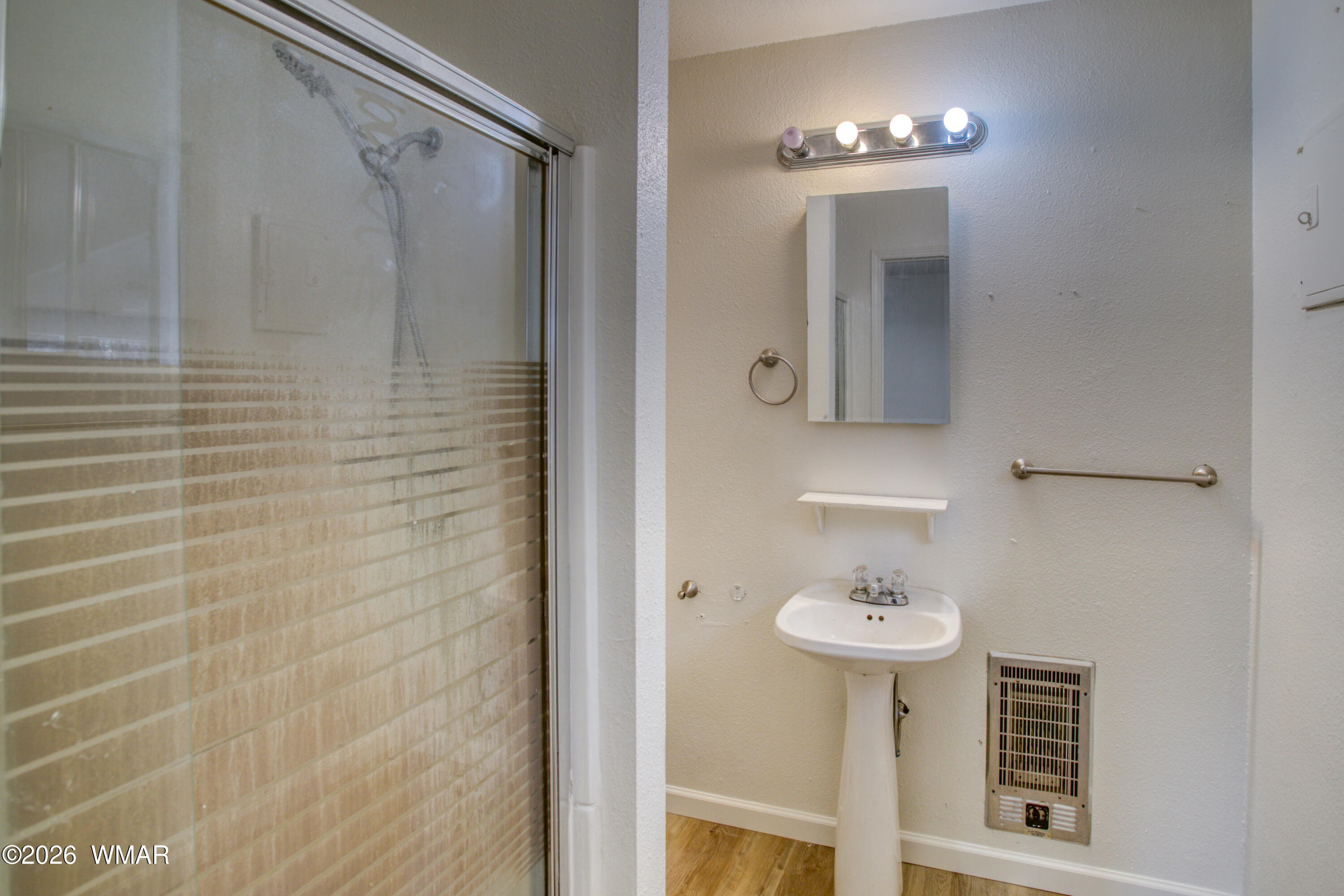 94 Southlake Road Lakeside, AZ 85929 - Photo 8 of 16 a bathroom with a sink a mirror and shower