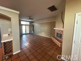 an empty room with windows and ceiling fan