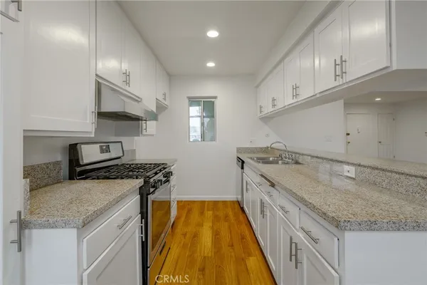 a kitchen with a stove and a sink