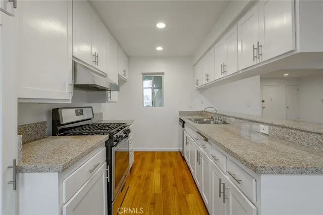 a kitchen with a stove and a sink