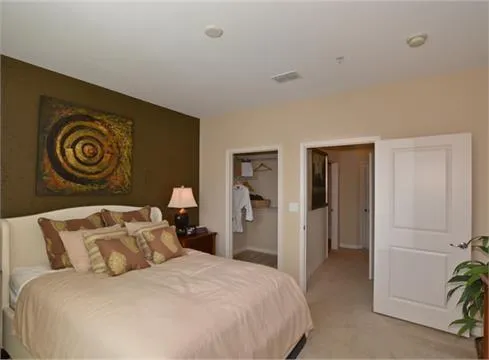 a bedroom with a bed and a potted plant