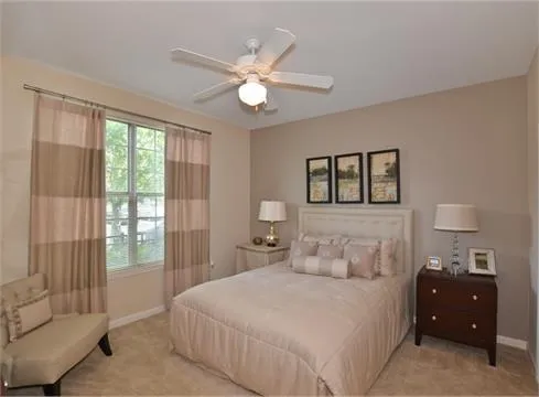 a bedroom with a large bed and a window