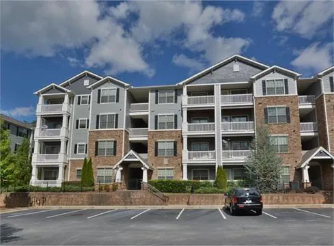 a front view of a residential apartment building with a yard