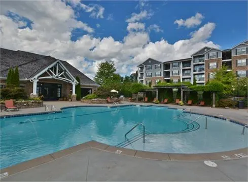 a view of a patio with a table and chairs under an umbrella