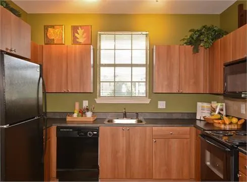 a kitchen with granite countertop a sink stove and refrigerator