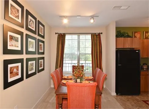 a dining room with furniture and window